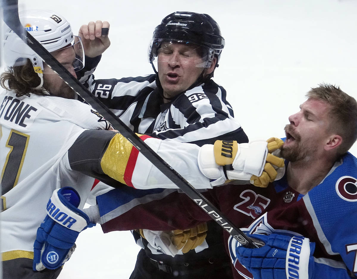 Linesman Mark Shewchyk (92) tries to break up a fight between Vegas Golden Knights right wing M ...