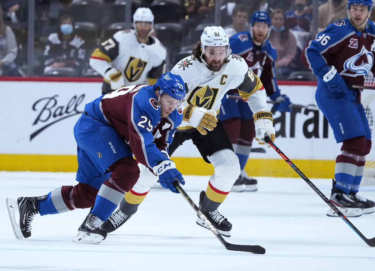 Colorado Avalanche center Nathan MacKinnon (29) moves the puck against Vegas Golden Knights rig ...