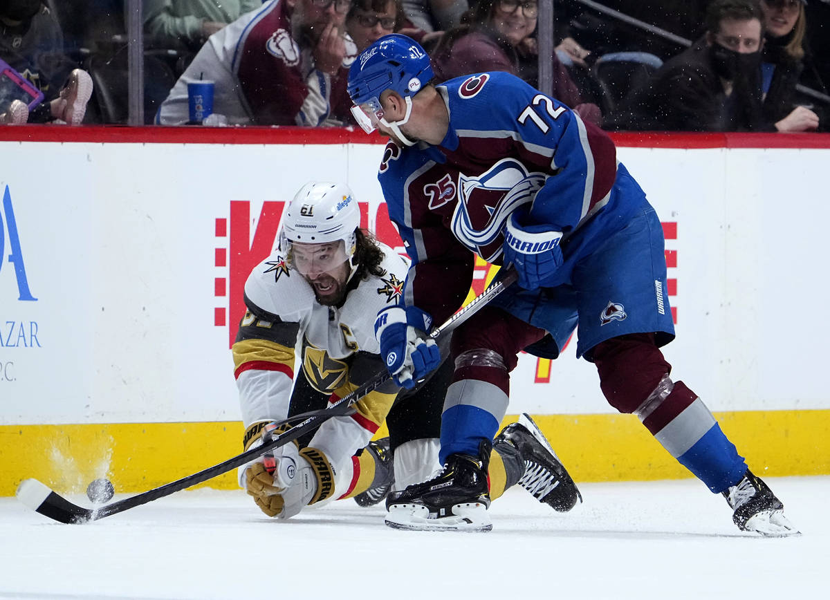Vegas Golden Knights right wing Mark Stone (61) dives to get the puck from Colorado Avalanche r ...