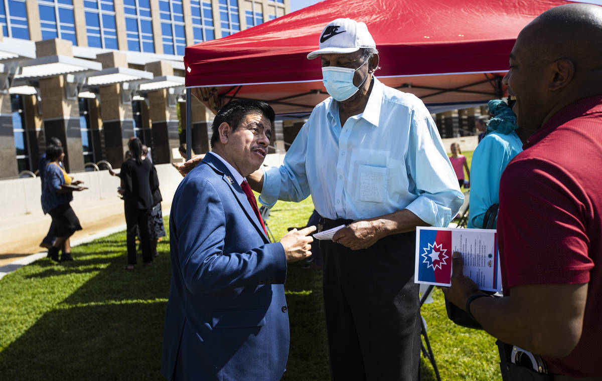 North Las Vegas Councilman Isaac Barron, left,t alks with former Nevada Assemblyman Harvey Munf ...