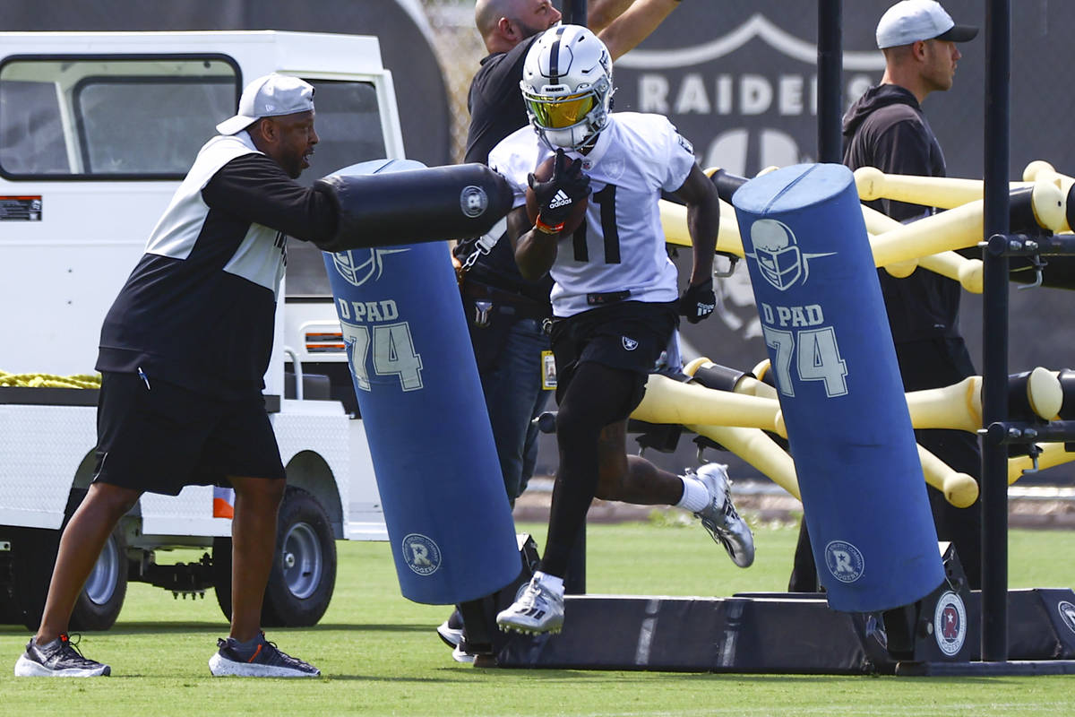 Raiders wide receiver Henry Ruggs III (11) runs through drills during NFL football practice at ...