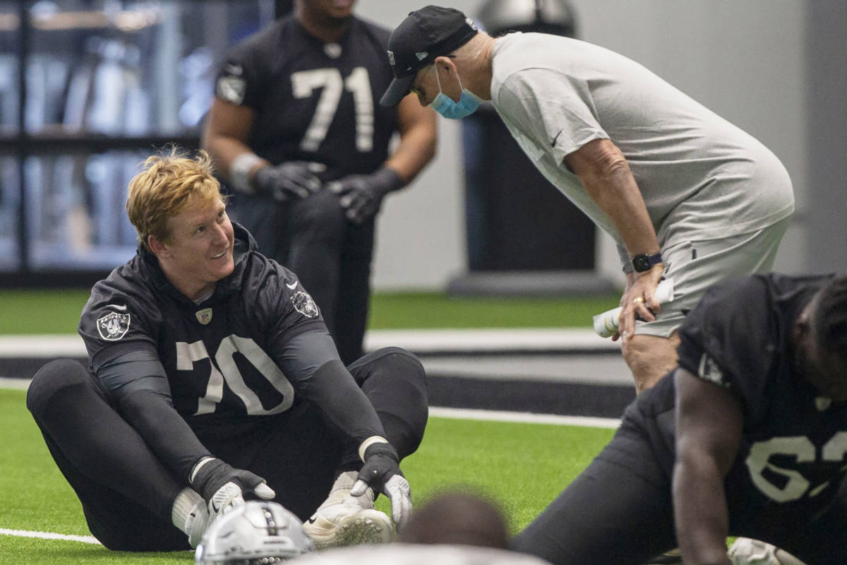 Las Vegas Raiders offensive tackle Sam Young (70) listens to defensive line coach Rod Marinelli ...