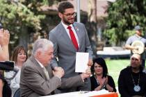 Gov. Steve Sisolak, left, shakes hands with Assemblyman Howard Watts, D-Las Vegas, after signin ...