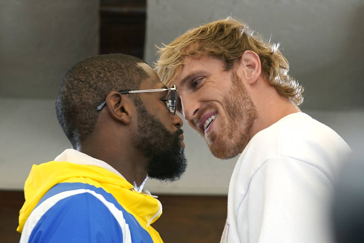 Floyd Mayweather, left, and and Logan Paul, right, face off during a press event, Thursday, Jun ...