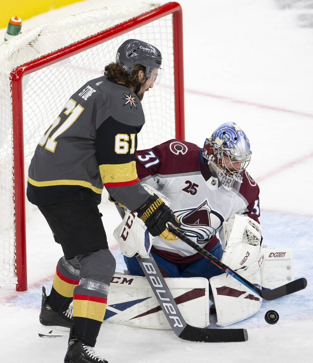 Golden Knights right wing Mark Stone (61) attempts a shot on Avalanche right wing Logan O'Conno ...