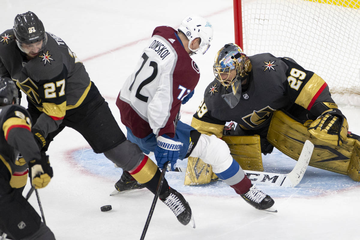 Golden Knights goaltender Marc-Andre Fleury (29) looks to save the puck as Avalanche right wing ...