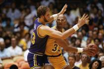 Mark Eaton of the Utah Jazz seems to have Los Angeles Lakers player Kareem Abdul-Jabbar in hand ...
