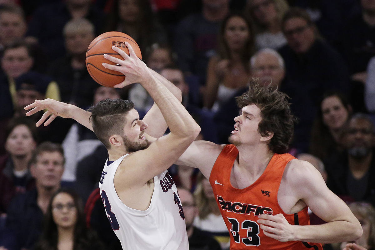 Gonzaga forward Killian Tillie, left, grabs a rebound against Pacific center James Hampshire du ...