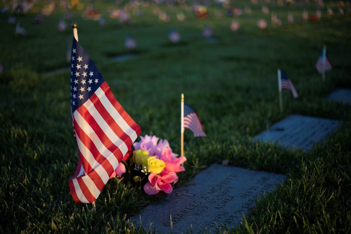 The sun sets on a Korean War veteran's grave on Memorial Day at the Southern Nevada Veterans Me ...