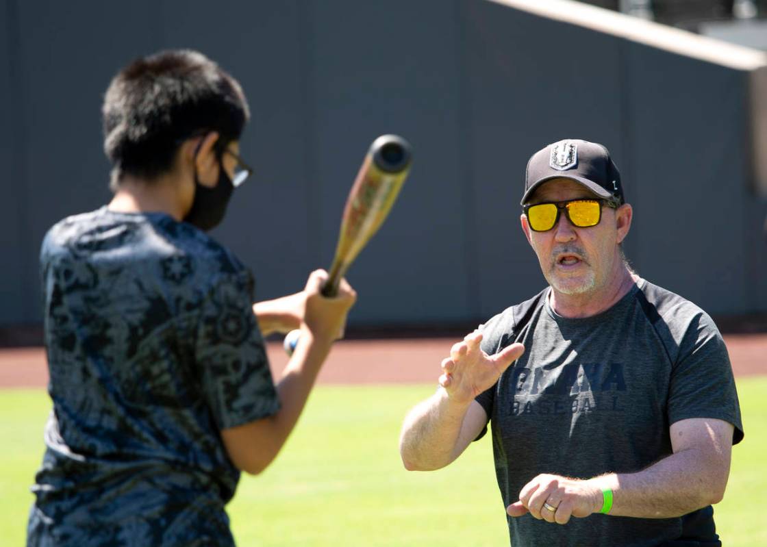 Mike Shannon, county liason for Clark County Commissioner Justin Jones, teaches batting skills ...