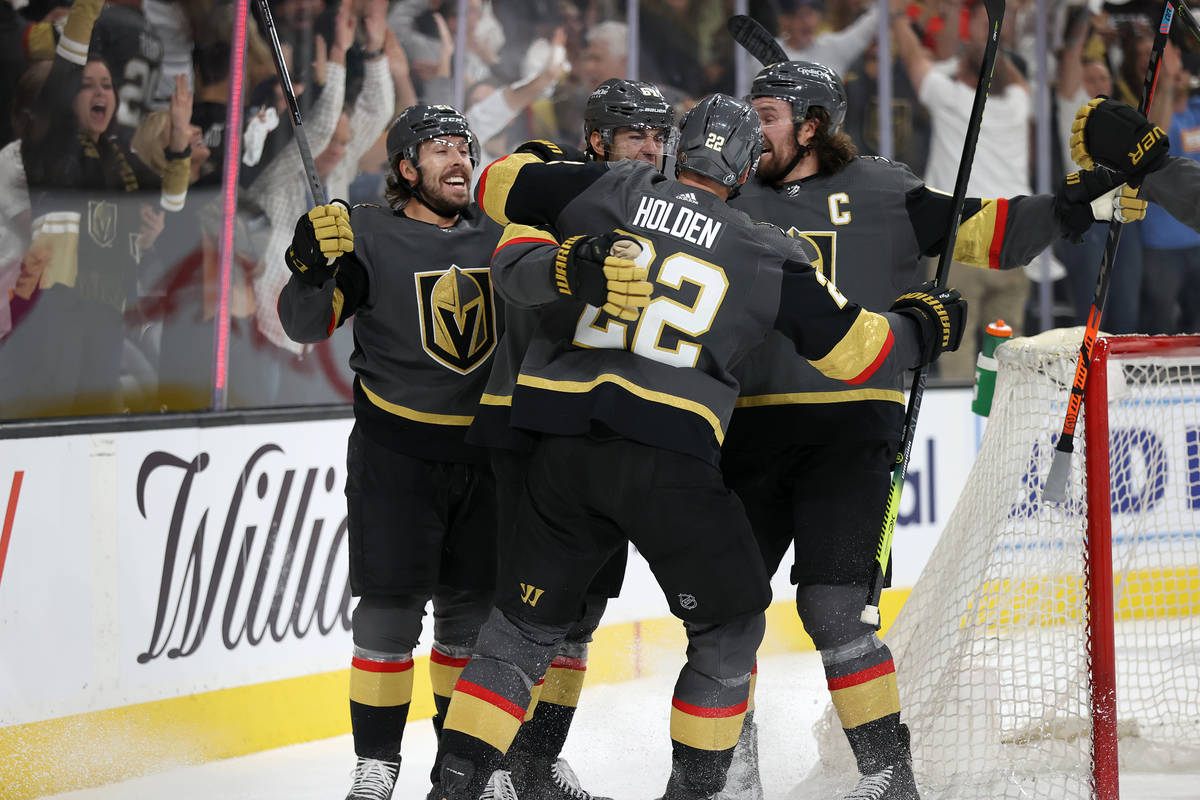 Vegas Golden Knights left wing Max Pacioretty (67) celebrates a score with defenseman Nick Hold ...