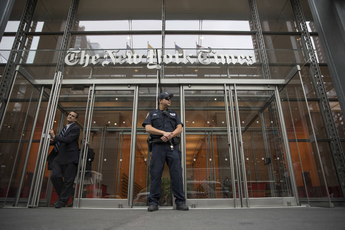 FILE - In this June 28, 2018, file photo, a police officer stands outside The New York Times bu ...