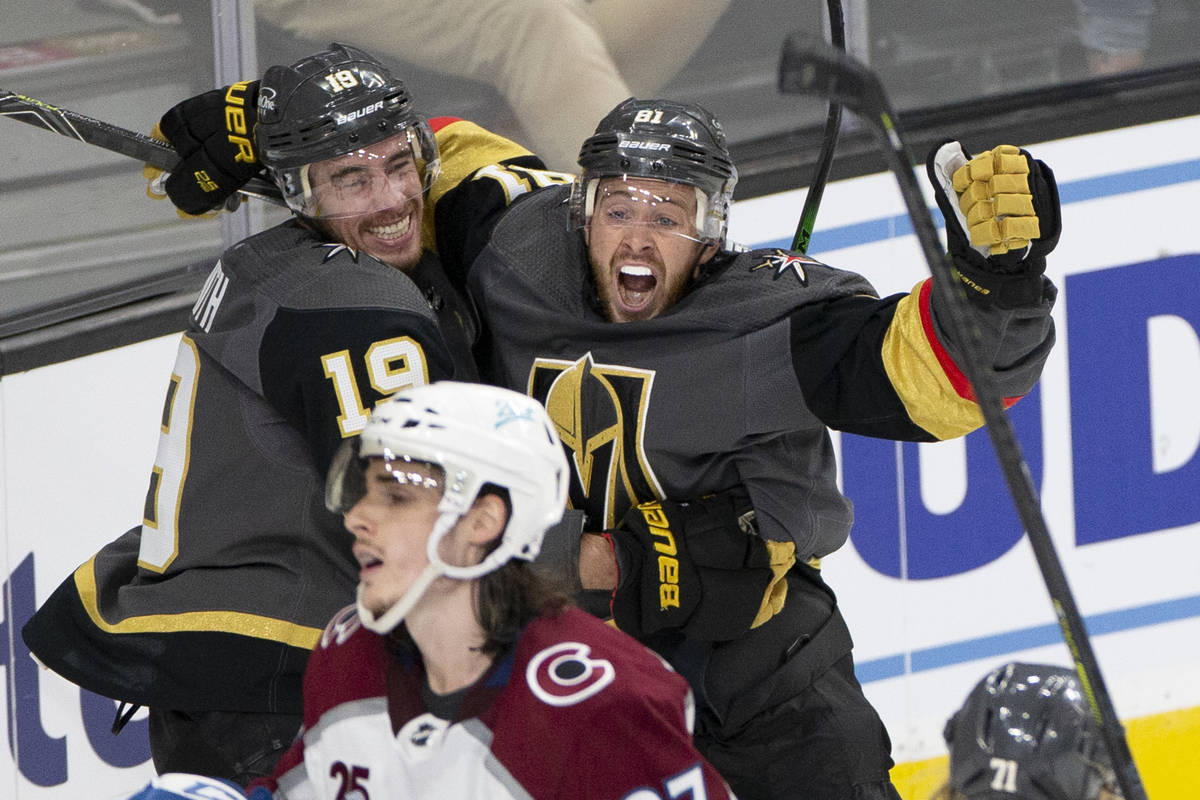 Golden Knights right wing Reilly Smith (19) embraces Golden Knights center Jonathan Marchessaul ...