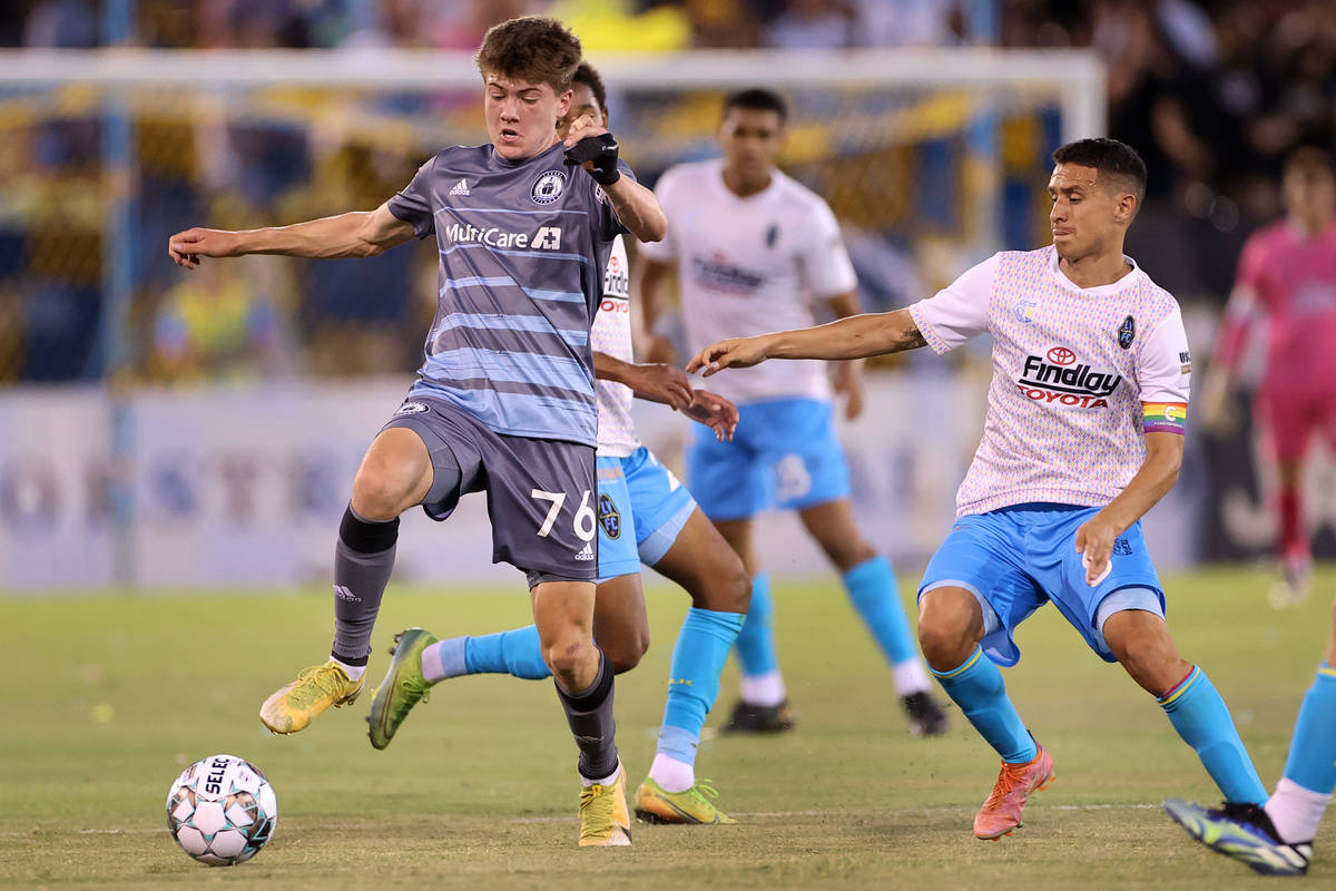 Las Vegas Lights Daniel Crisostomo (8) and Tacoma Defiance Reed Baker-Whiting (76) fight for th ...