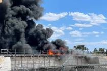 Smoke billows Saturday, June 5, 2021, from a fire on railroad tracks at a bridge in North Las V ...