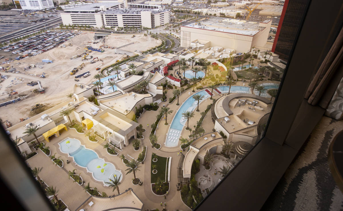 A view of the pool area is seen from a Conrad suite during a tour of Resorts World ahead of it' ...