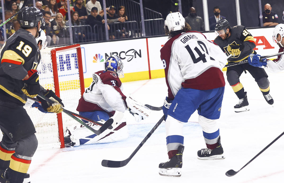 Golden Knights' Jonathan Marchessault, right, gets the puck past Colorado Avalanche goaltender ...