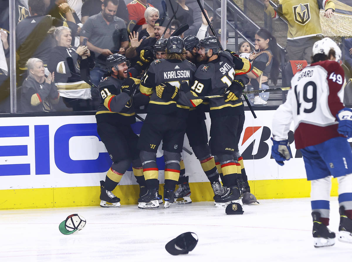 Golden Knights' Jonathan Marchessault, left, is mobbed by teammates after scoring a hat trick i ...