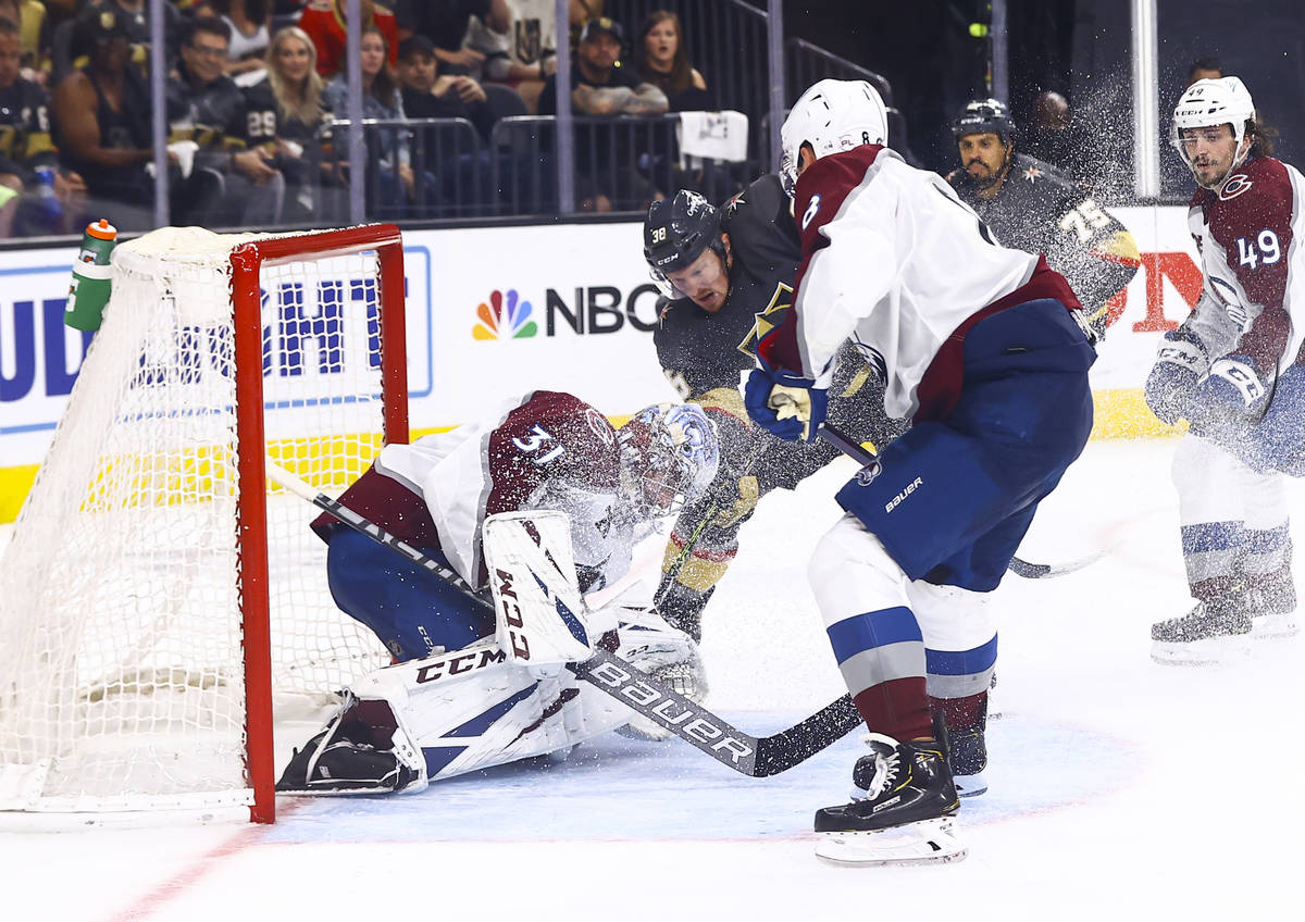 Golden Knights' Patrick Brown (38) fights to get the puck past Colorado Avalanche goaltender Ph ...