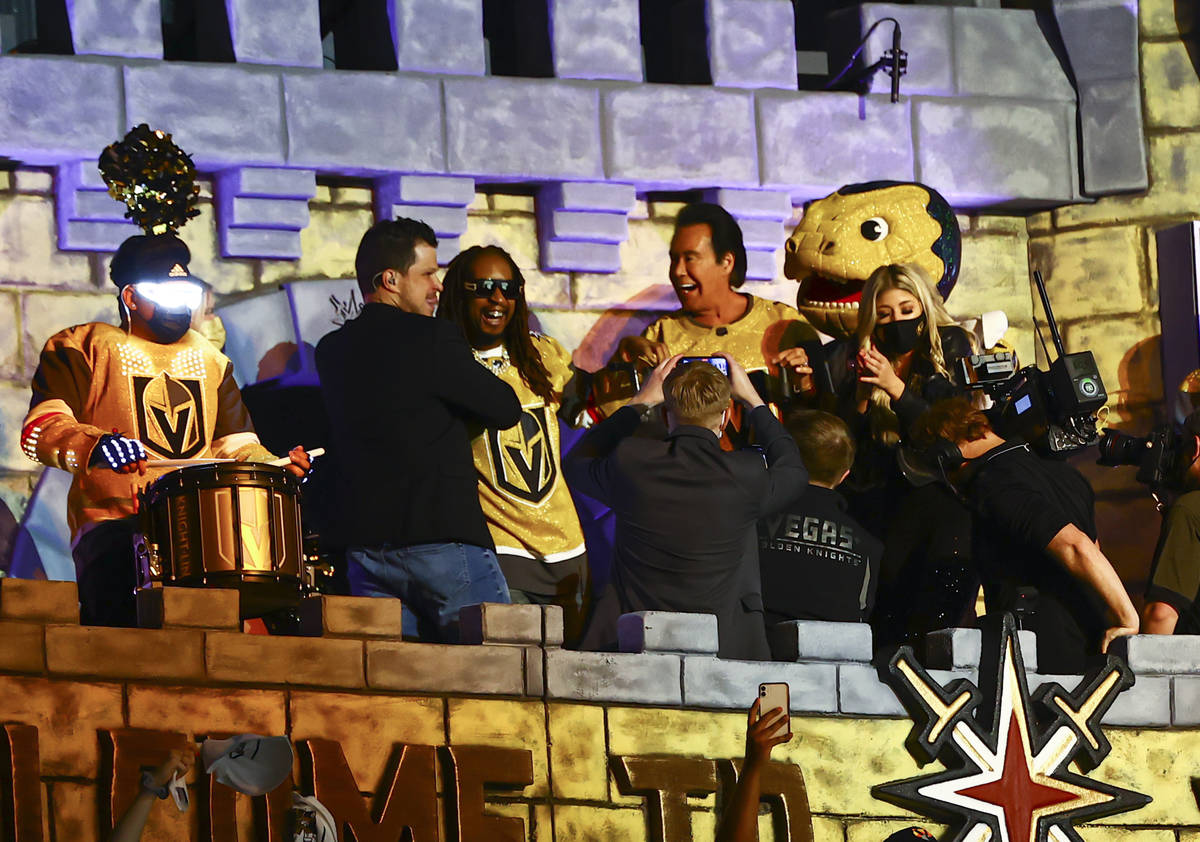 LilÕ Jon, center left, and Wayne Newton help kickoff Game 4 of an NHL hockey Stanley Cup s ...