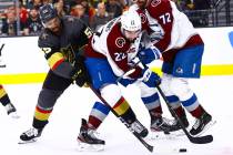 Golden Knights' Keegan Kolesar (55) battles for the puck against Colorado Avalanche's Conor Tim ...