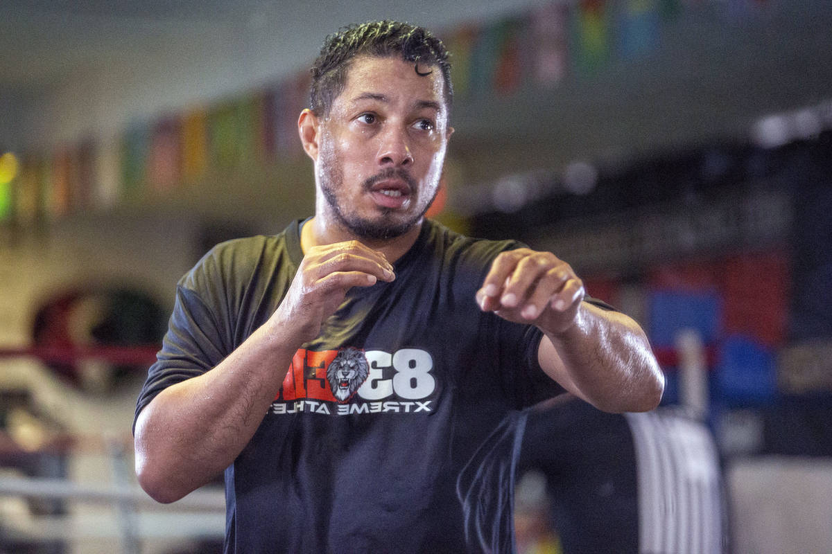 Hector Camacho, Jr. shadow boxes in a mirror in preparation for his exhibition bout against Jul ...