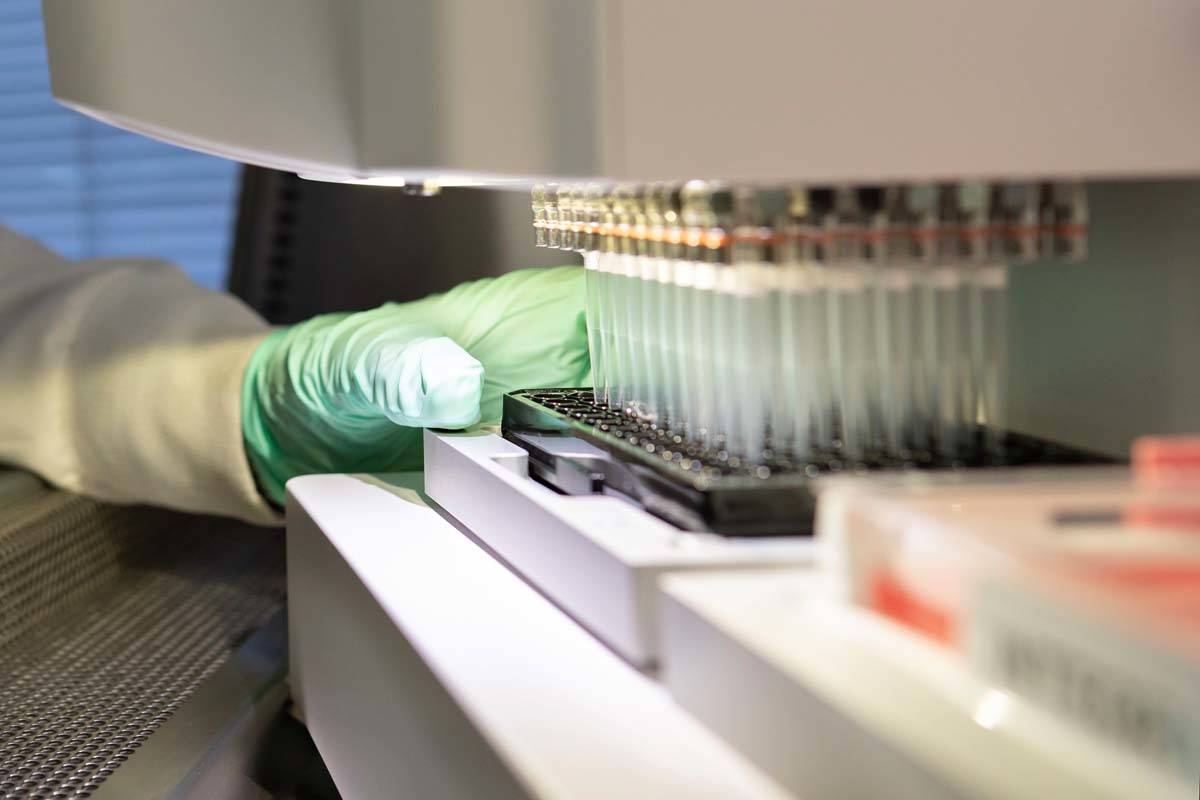 In this 2019 photo provided by Biogen, a researcher works on the development of the medication ...