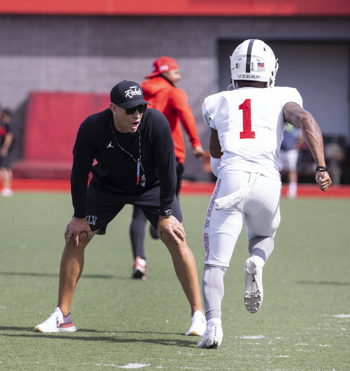 UNLV men's football head coach Marcus Arroyo watches as wide receiver Kyle Williams (1) sprints ...