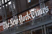 In this Thursday, May 6, 2021 file photo, a sign for The New York Times hangs above the entranc ...