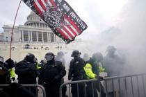 In this Jan. 6, 2021, U.S. Capitol Police officers hold off rioters loyal to President Donald T ...