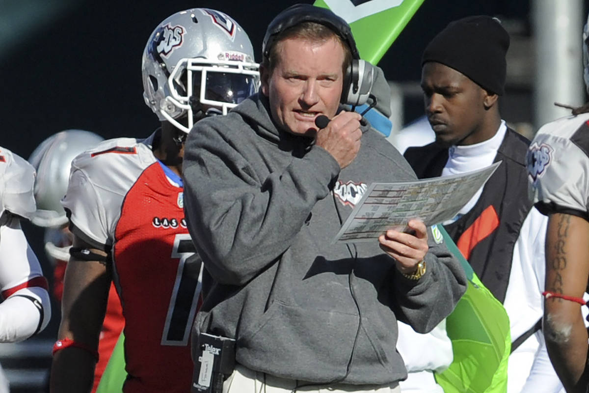 FILE - In this Nov. 27, 2010, file photo, then Las Vegas head coach Jim Fassel, center, looks o ...