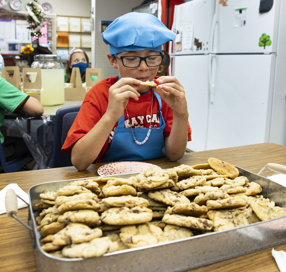Kay Carl Elementary School student, Casey Piplic, 7, tests a cookie made by schoolmates during ...