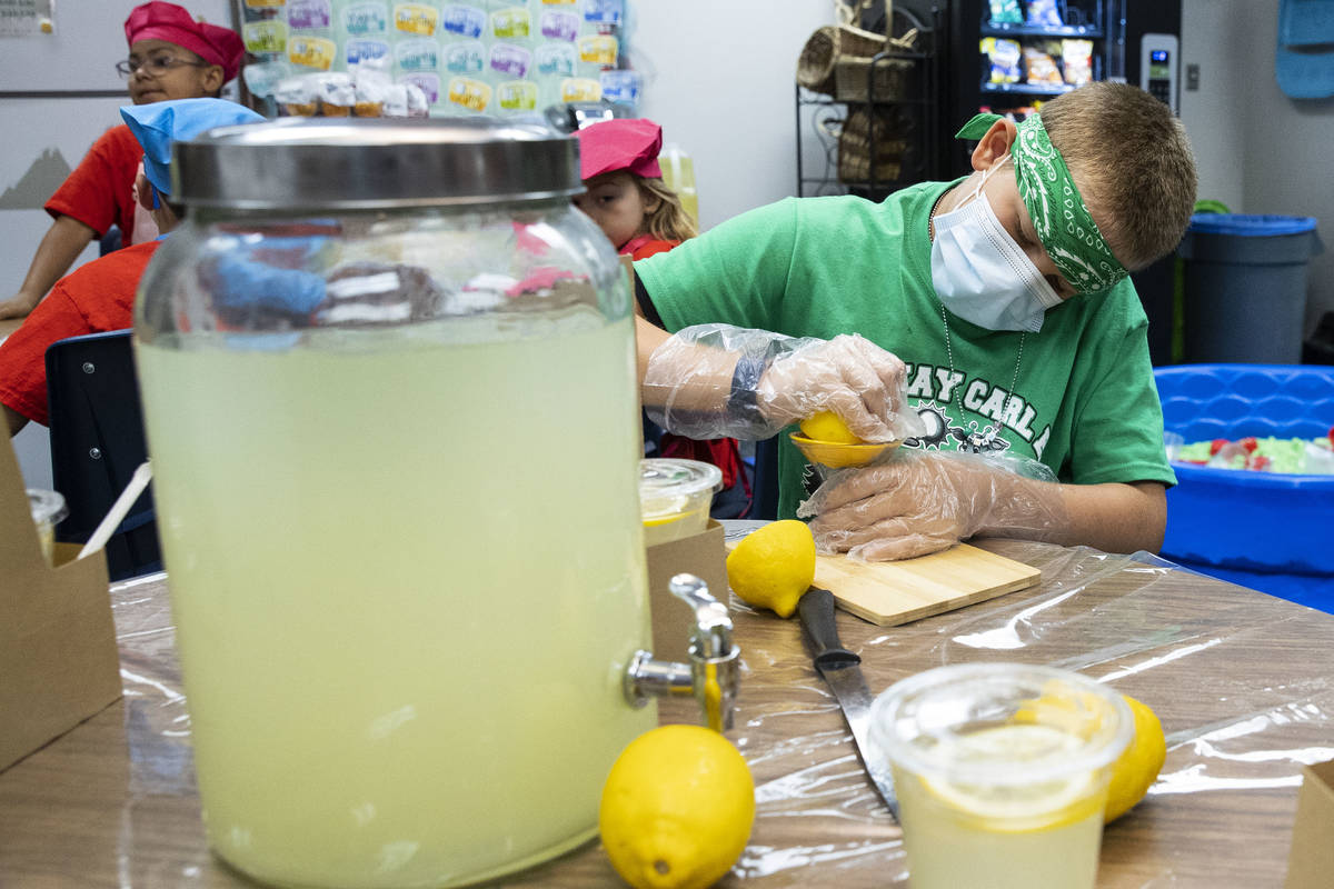 Kay Carl Elementary School student, Shawn Davignon, 11, squeezes a lemon to make lemonade durin ...