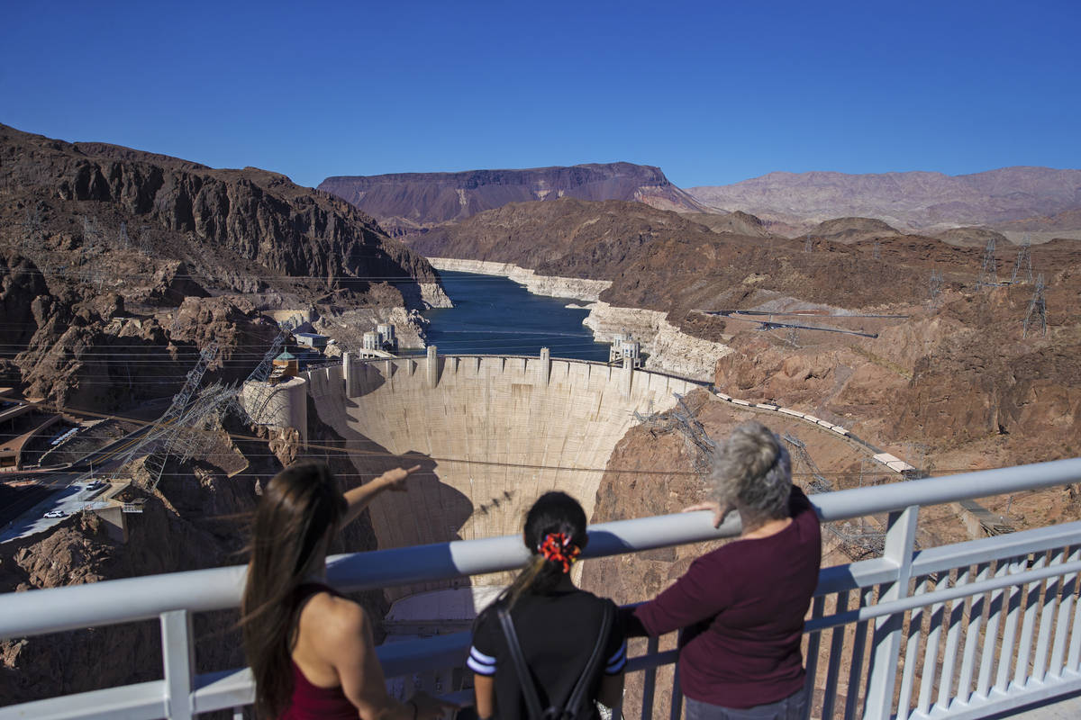 Abigail and Veronica Jones, left, and Pamela Smith look out at Lake Mead and the Hoover Dam whi ...