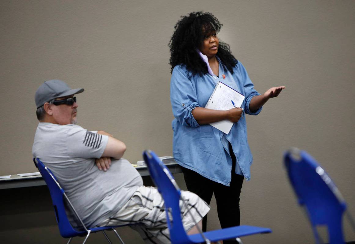 Kimberly Ireland of Spring Valley, who is facing eviction, asks a question during a Housing Res ...