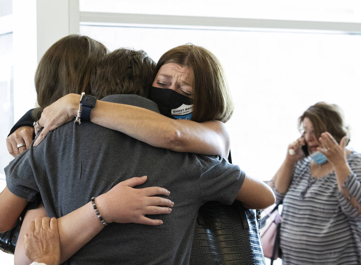 Angela Ahmet, right, hugs her daughter Jasmine, 17, and her son Eren after Jordan BarsonÕs ...