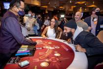 Matt James, right, with Melissa George, center, reacts to the final card being laid down as he ...