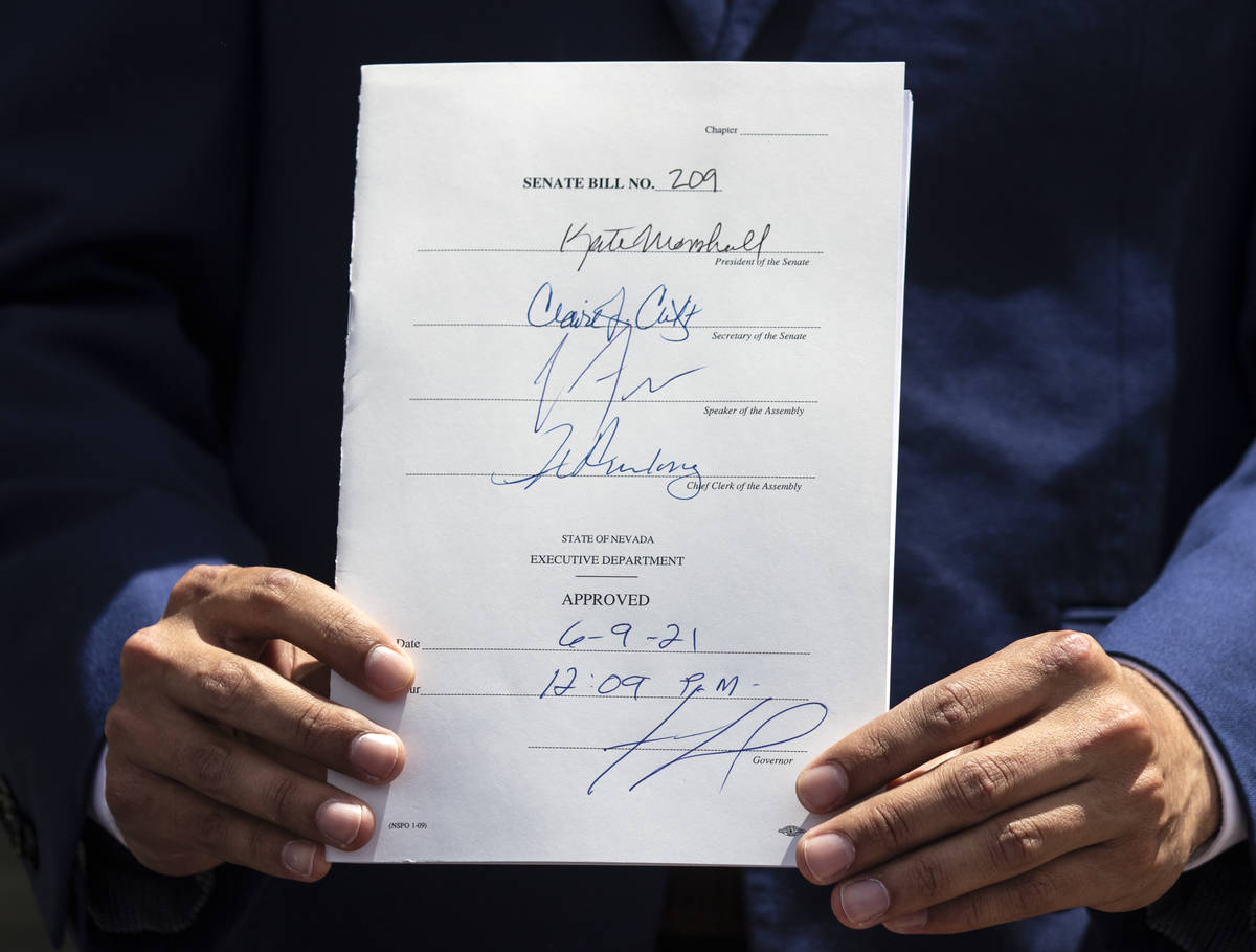 State Senator Fabian Donate holds Bill # 209 after Gov. Steve Sisolak signed the bill, on Wedne ...