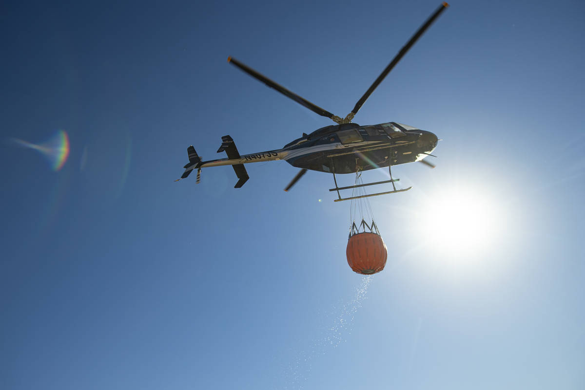 Rick Thielmann, chief pilot at the Nevada Department of Wildlife, hauls water using a Bambi buc ...
