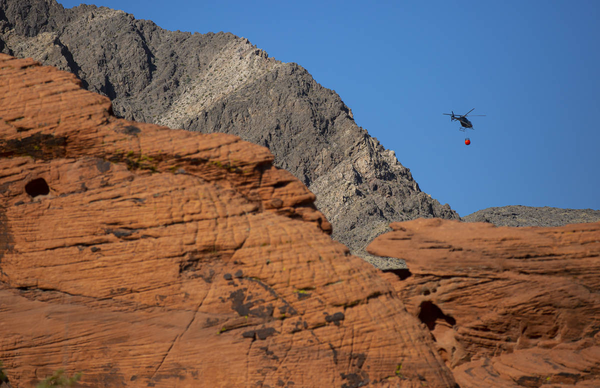 Rick Thielmann, chief pilot at the Nevada Department of Wildlife, hauls water using a Bambi buc ...