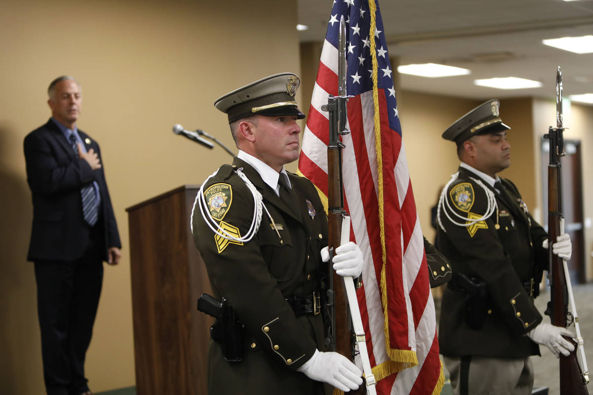 Clark County Sheriff Joe Lombardo, background, honor guards Sgt. Brian Leahy, left, Officer Rya ...