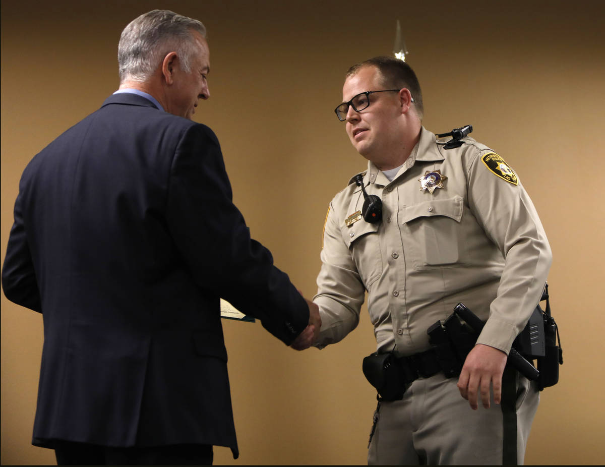 Clark County Sheriff Joe Lombardo, left, shakes hands with Officer Christopher Ira Allen, a lif ...