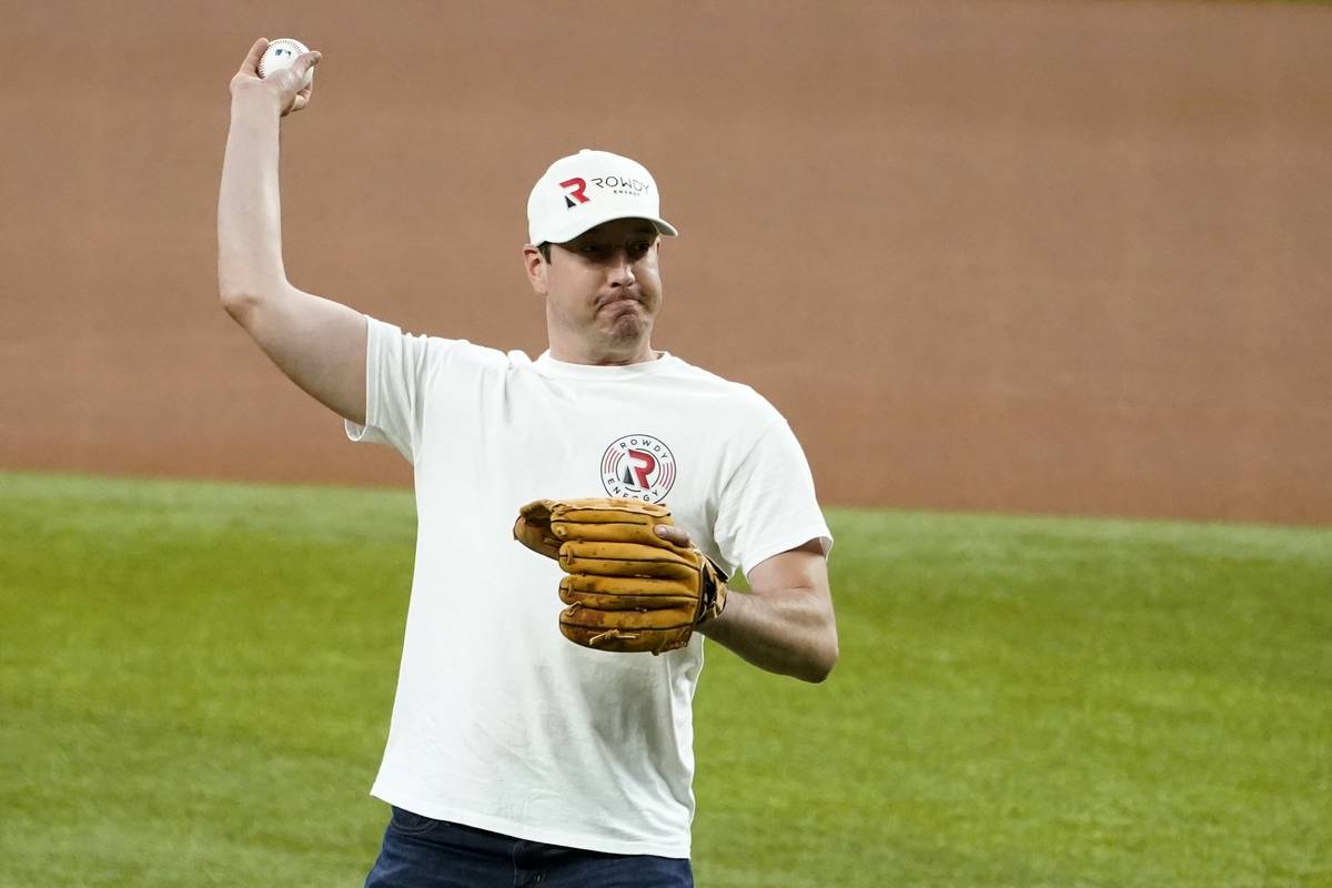 NASCAR driver Kyle Busch throws out the ceremonial first pitch before a baseball game between t ...