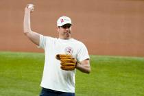 NASCAR driver Kyle Busch throws out the ceremonial first pitch before a baseball game between t ...