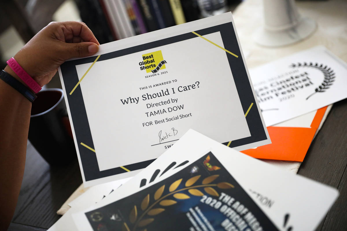 Tamia Dow sorts through awards and recognitions for her work at her friend's home in Las Vegas ...