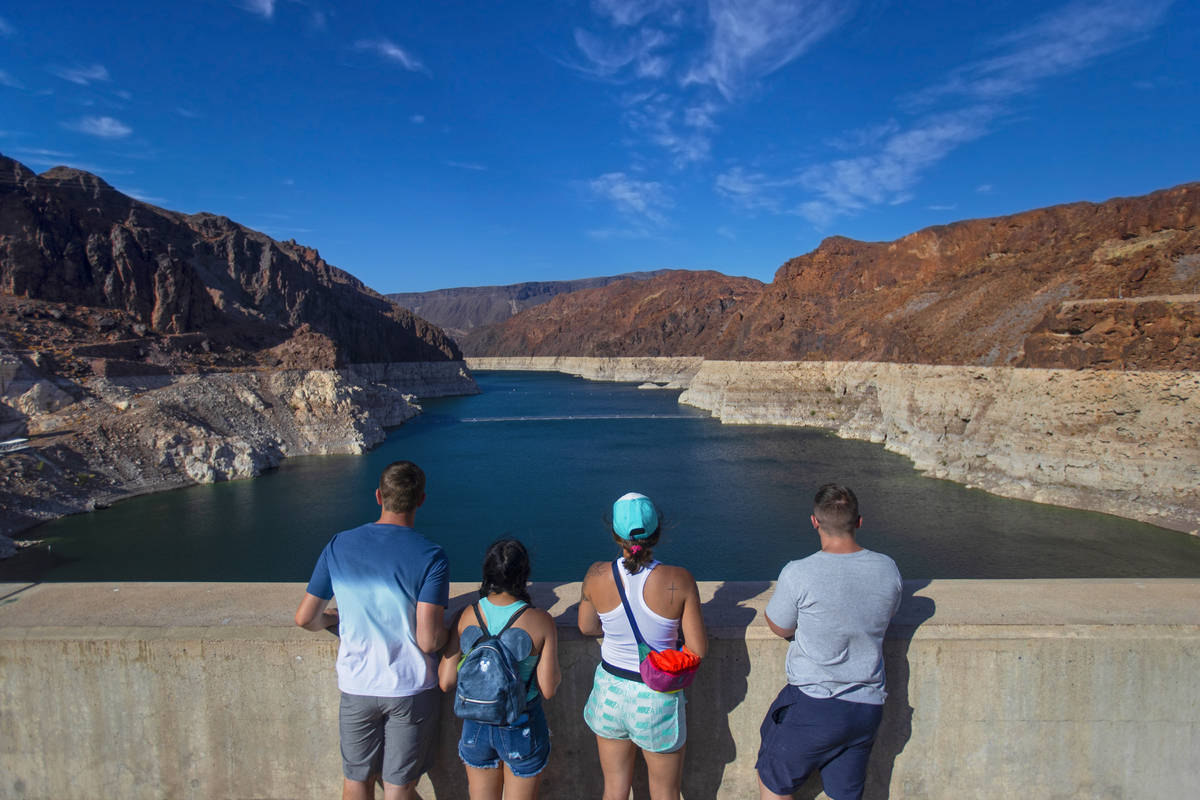 Tourists look out at Lake Mead from the top of the Hoover Dam on Tuesday, June 8, 2021, in Boul ...