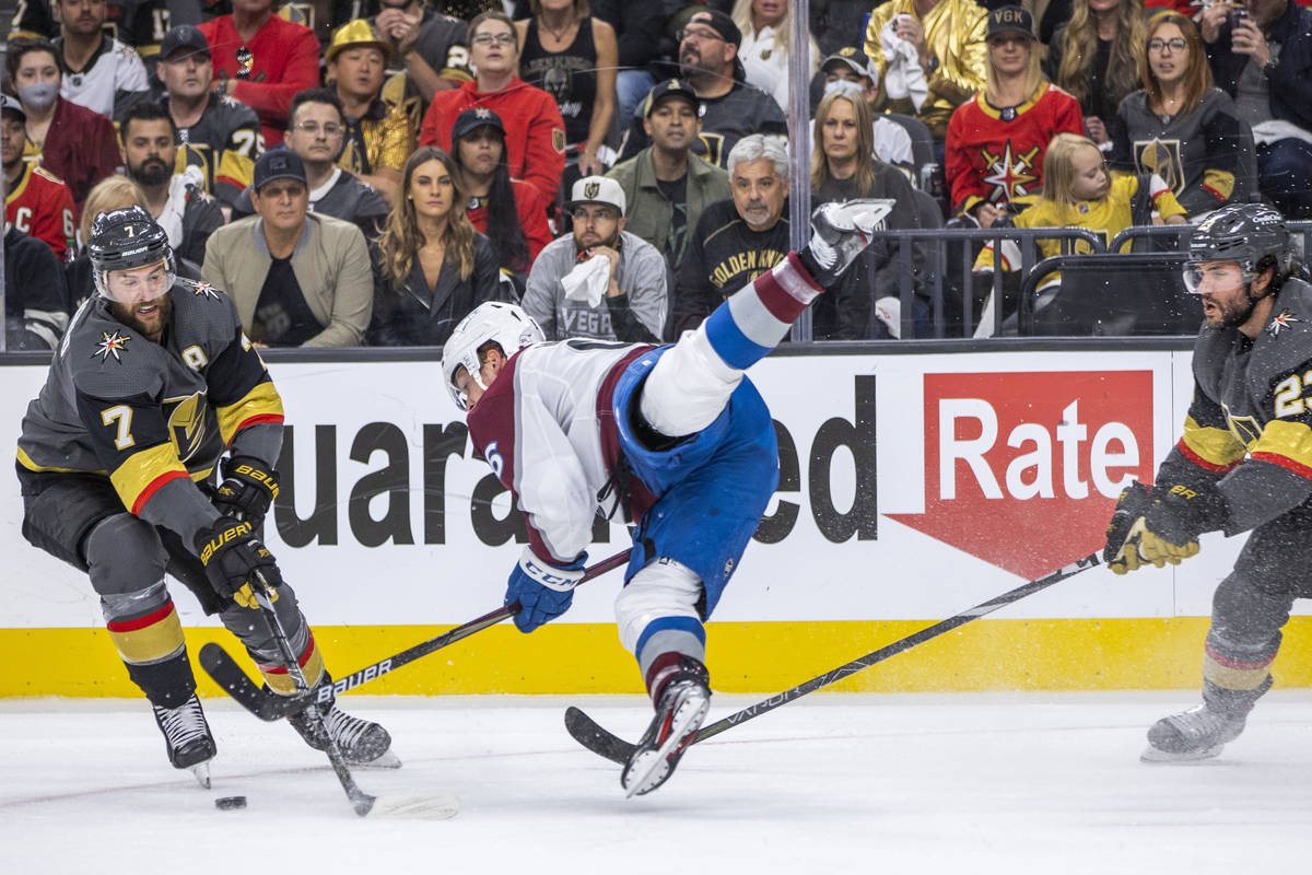 Colorado Avalanche right wing Mikko Rantanen (96) is upended between Golden Knights defenseman ...