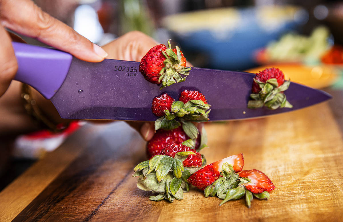 Regina Mitchell, a chef/instructor with Blindconnect, cuts strawberries on Friday, June 11, 202 ...