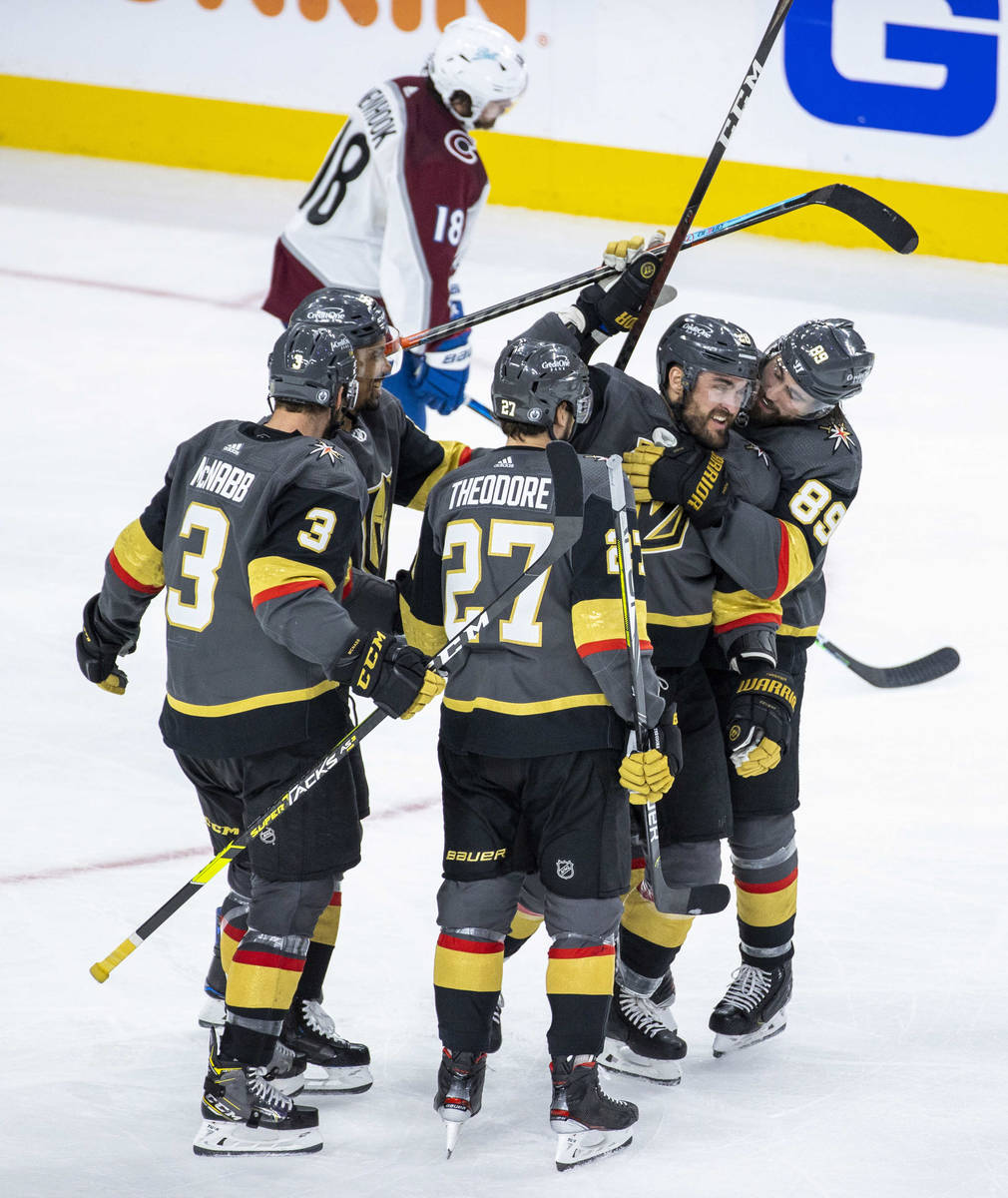 Golden Knights left wing William Carrier (28) is hugged by Golden Knights right wing Alex Tuch ...