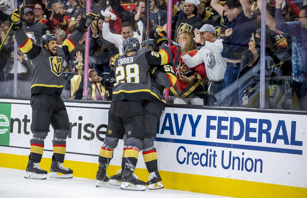 Golden Knights right wing Ryan Reaves (75) celebrates a goal with teammates left wing William C ...